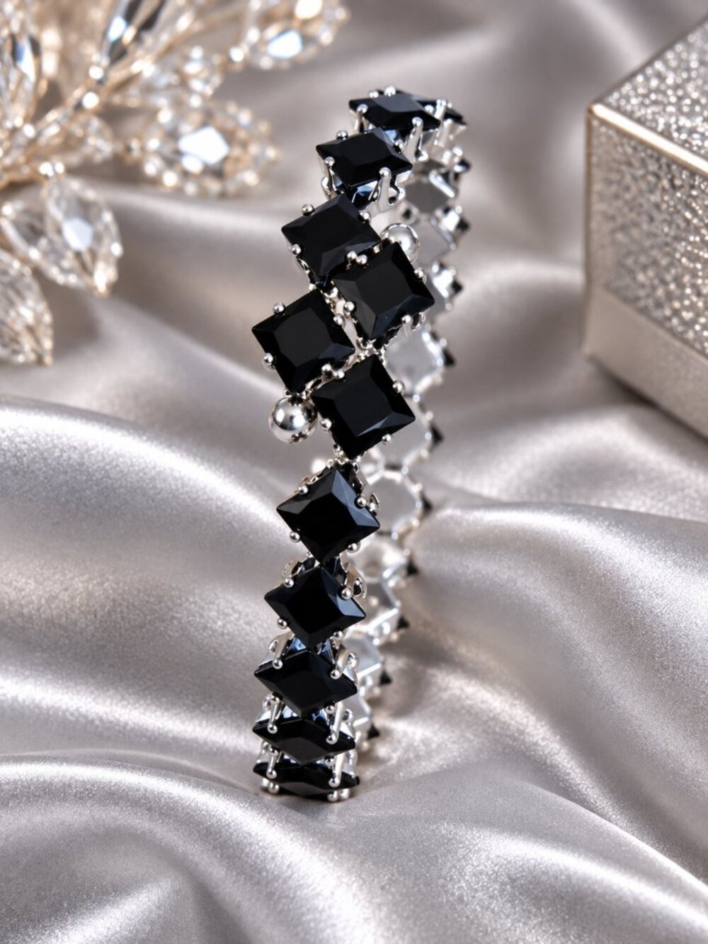 Silver-tone bracelet featuring faceted black square-cut stones